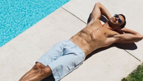 Man laying by swimming pool